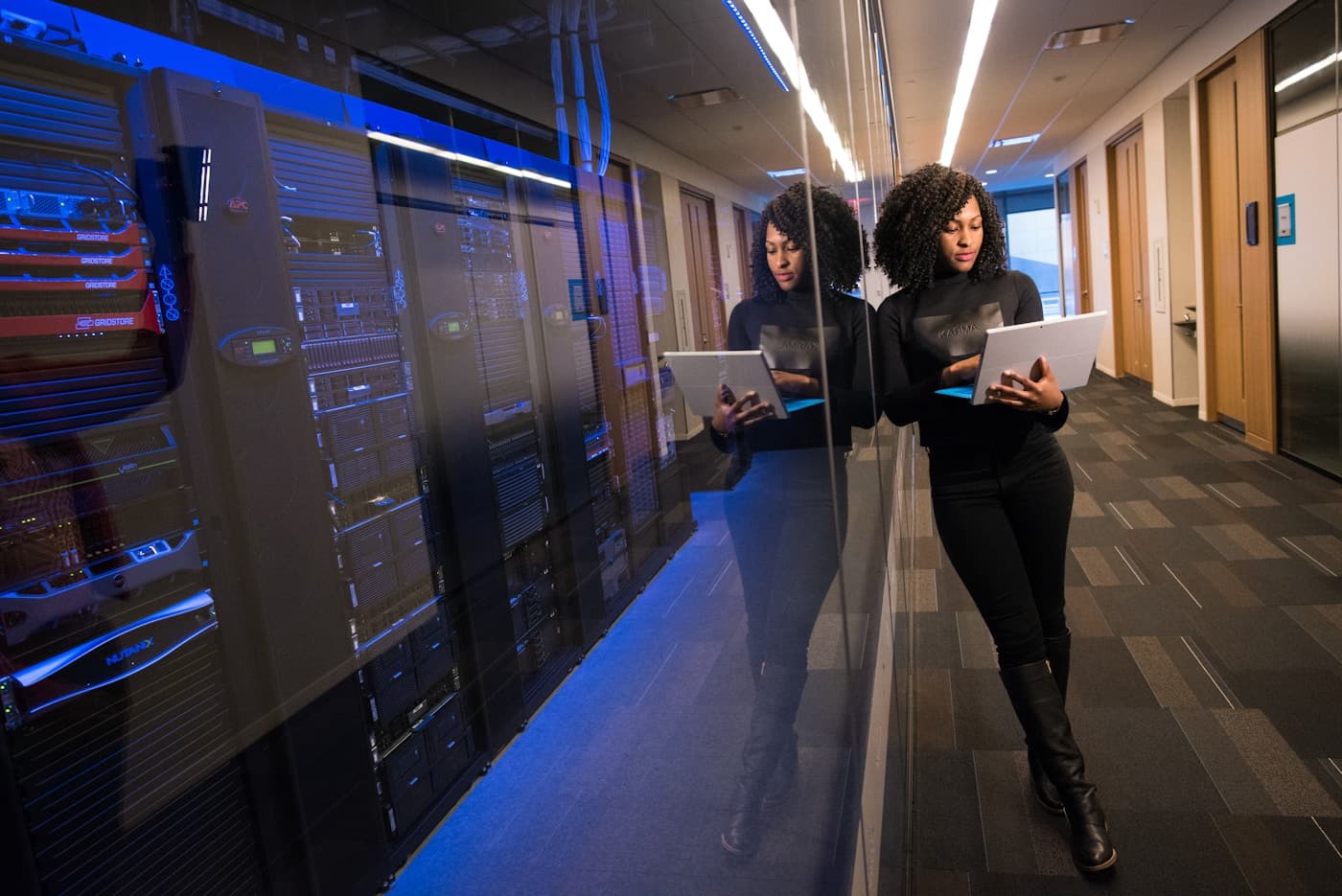 A technology professional at work in a modern data centre